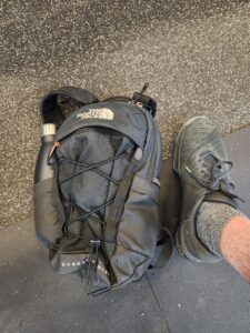 A small gray backpack, with my foot for scale